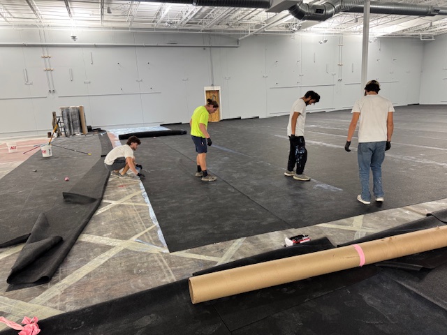 Crew installing rubber mat