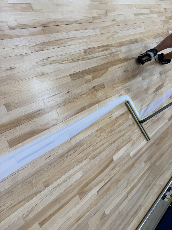 coating being applied to gym floor